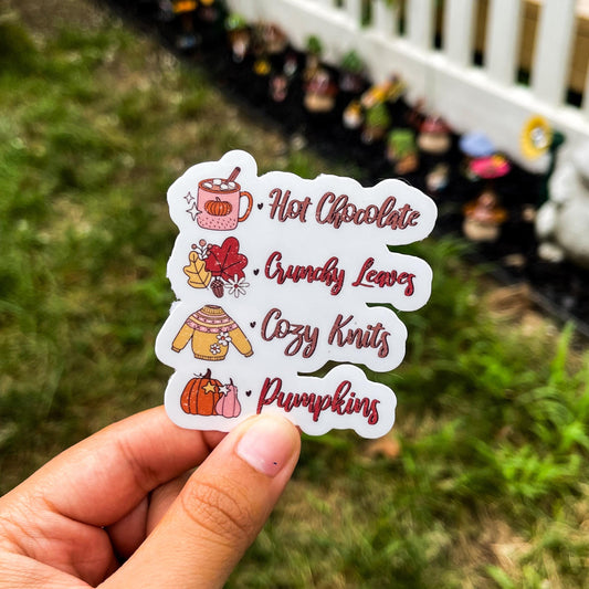 Fall checklist sticker featuring hot chocolate, crunchy leaves, cozy knits, and pumpkins.