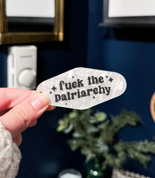 marble acrylic motel keychain with the lyrics "fuck the patriarchy" from all to well 10 minute version from taylor swift's album Red